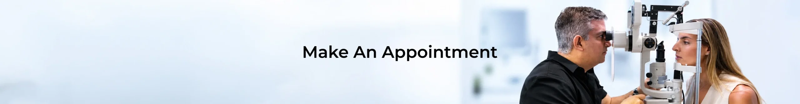 Banner with the text 'Make An Appointment' showing an optometrist performing an eye exam using a slit lamp on a patient.